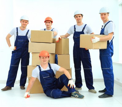 Moving crew carrying furniture through a Stratford apartment building