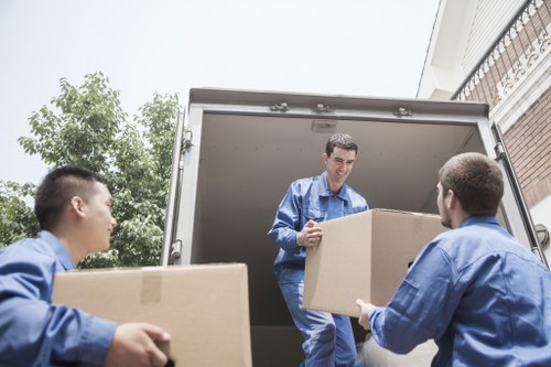 Moving team handling a Stratford home removal near apartment buildings