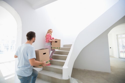 Removal team handling furniture in a Stratford apartment or flat