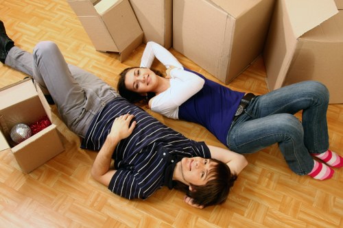 Staff coordinating a Stratford business relocation with labelled moving boxes