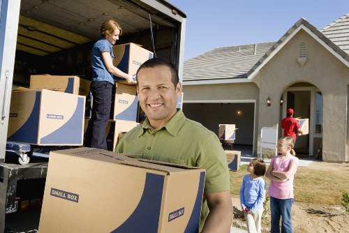 Packed moving boxes and furniture ready for a Stratford removals service